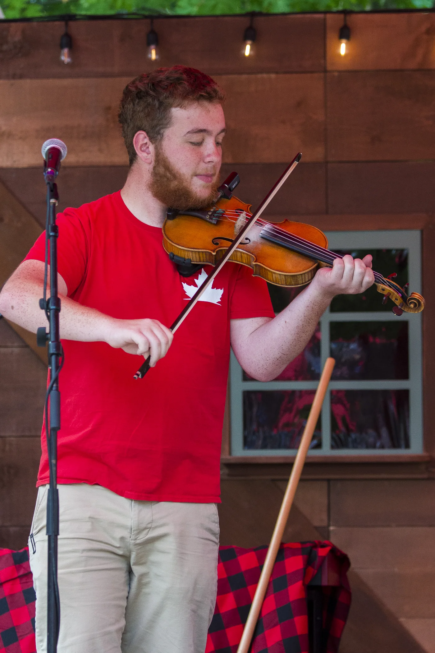 Liam playing fiddle on stage